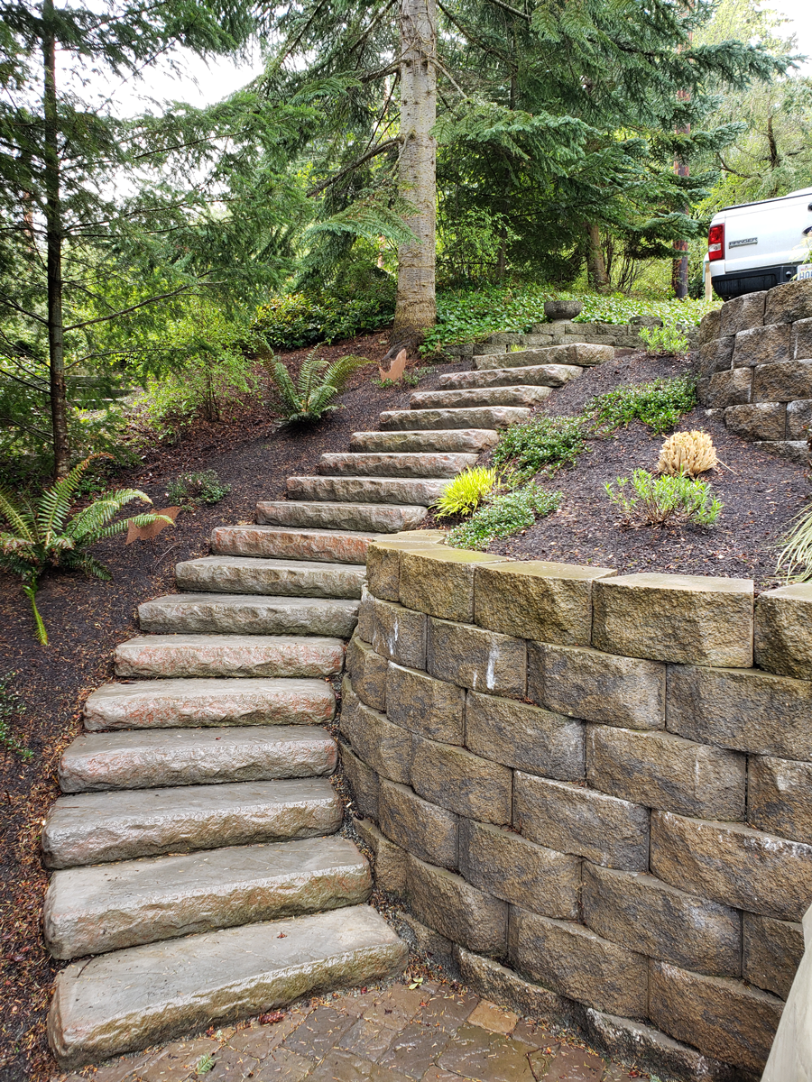 a set of stone stairs leading up to a stone wall .