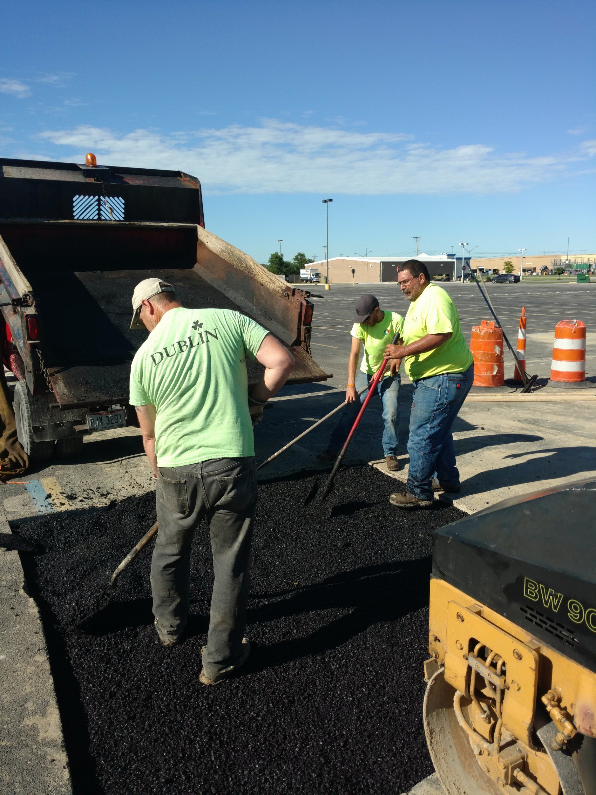 Dublin Commercial Property Services, Inc. technicians repairing a parking lot drain in Sandusky, Ohio.