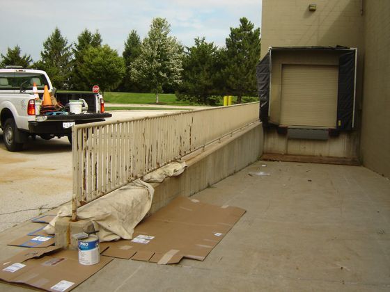 Dublin CPS, Inc. painting ramp railing in rear of commercial property
