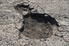 Closeup of a pothole found in a parking lot inspection performed by Northwest Ohio property maintenance company, Dublin CPS, Inc.