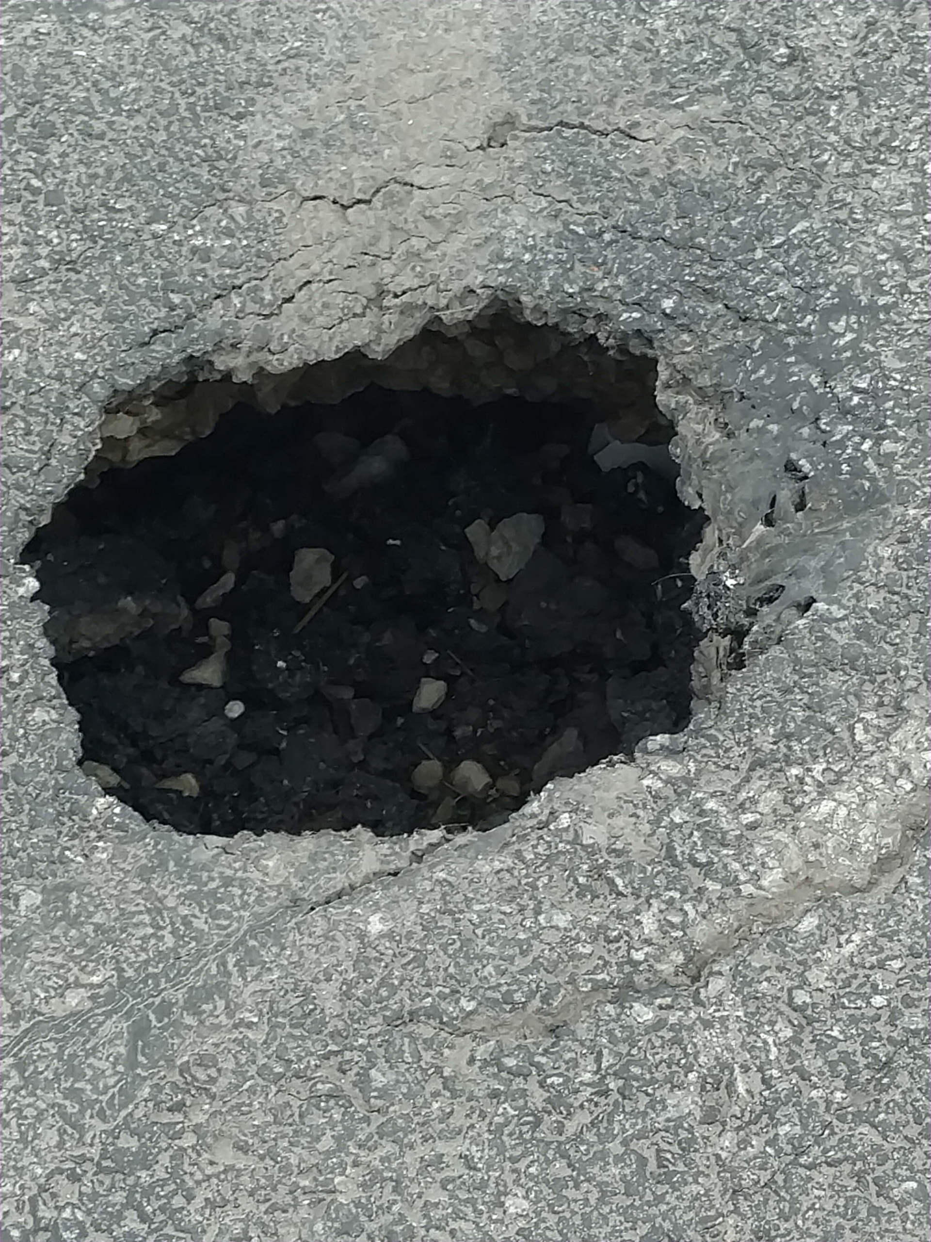 Pothole leading to a drain in need of repair in Sandusky, Ohio..