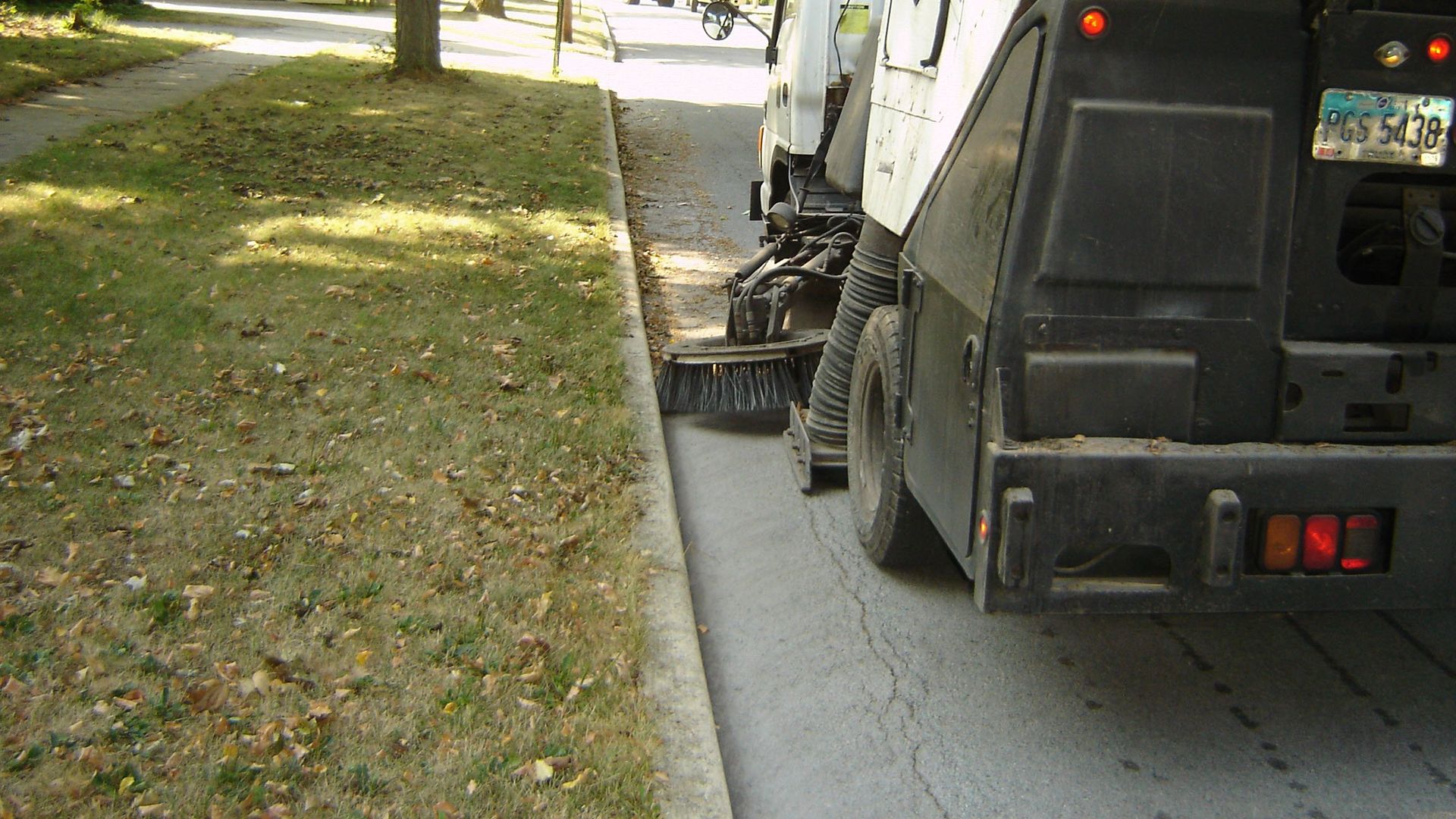 Sweeper truck cleaning up leaves