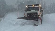 Plow truck clearing a commercial parking lot in Northwest Ohio.