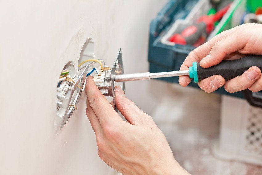 man working on electrical socket