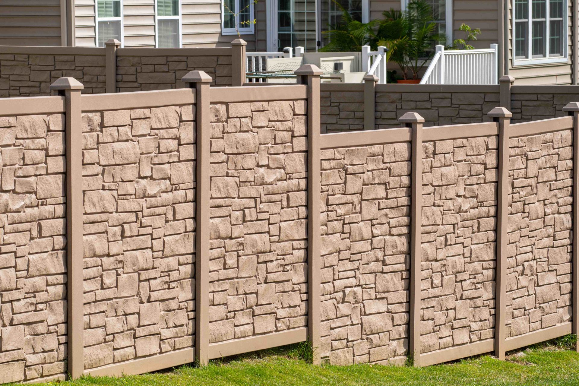 A vinyl fence with a brown brick appearance in Utah