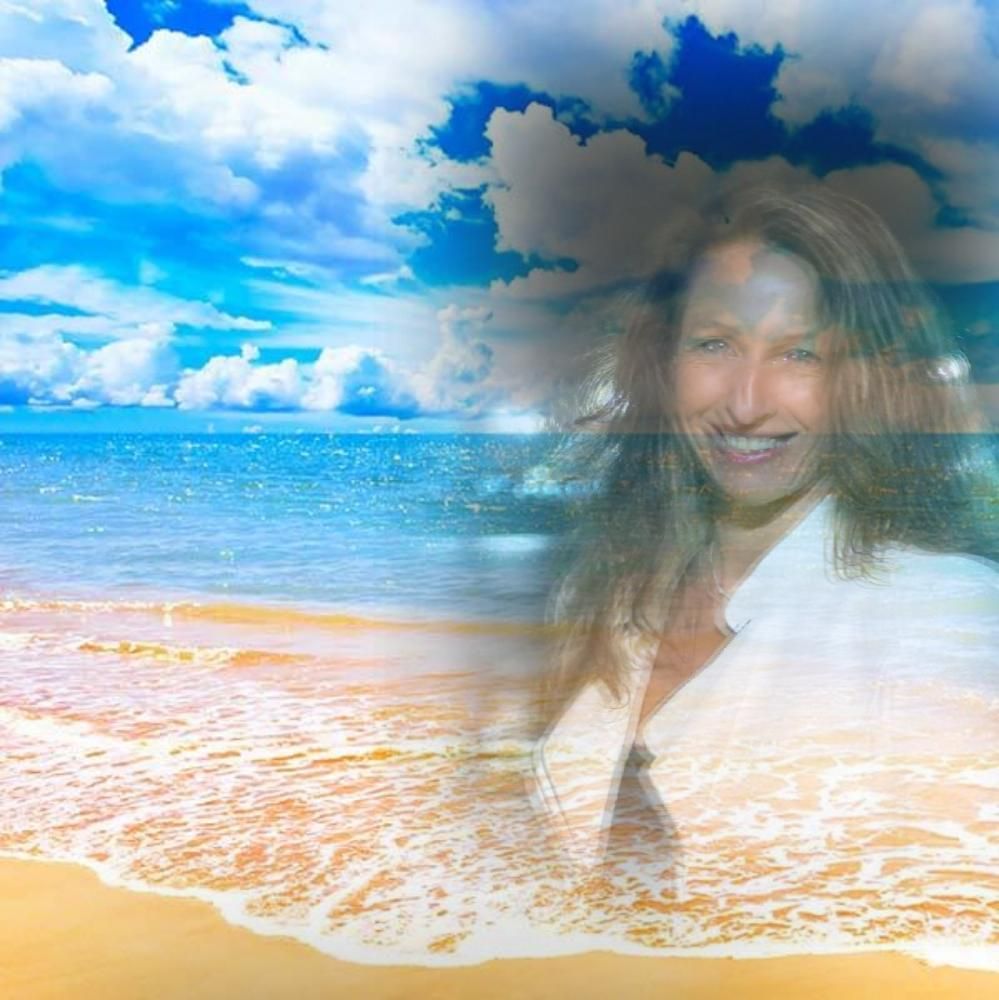 Woman smiling, overlaid on a sunny beach with blue sky and ocean.