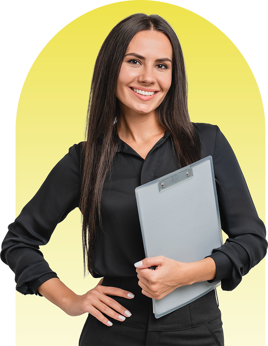 Woman with long dark hair, smiling, holding a clipboard, in front of a yellow arch.