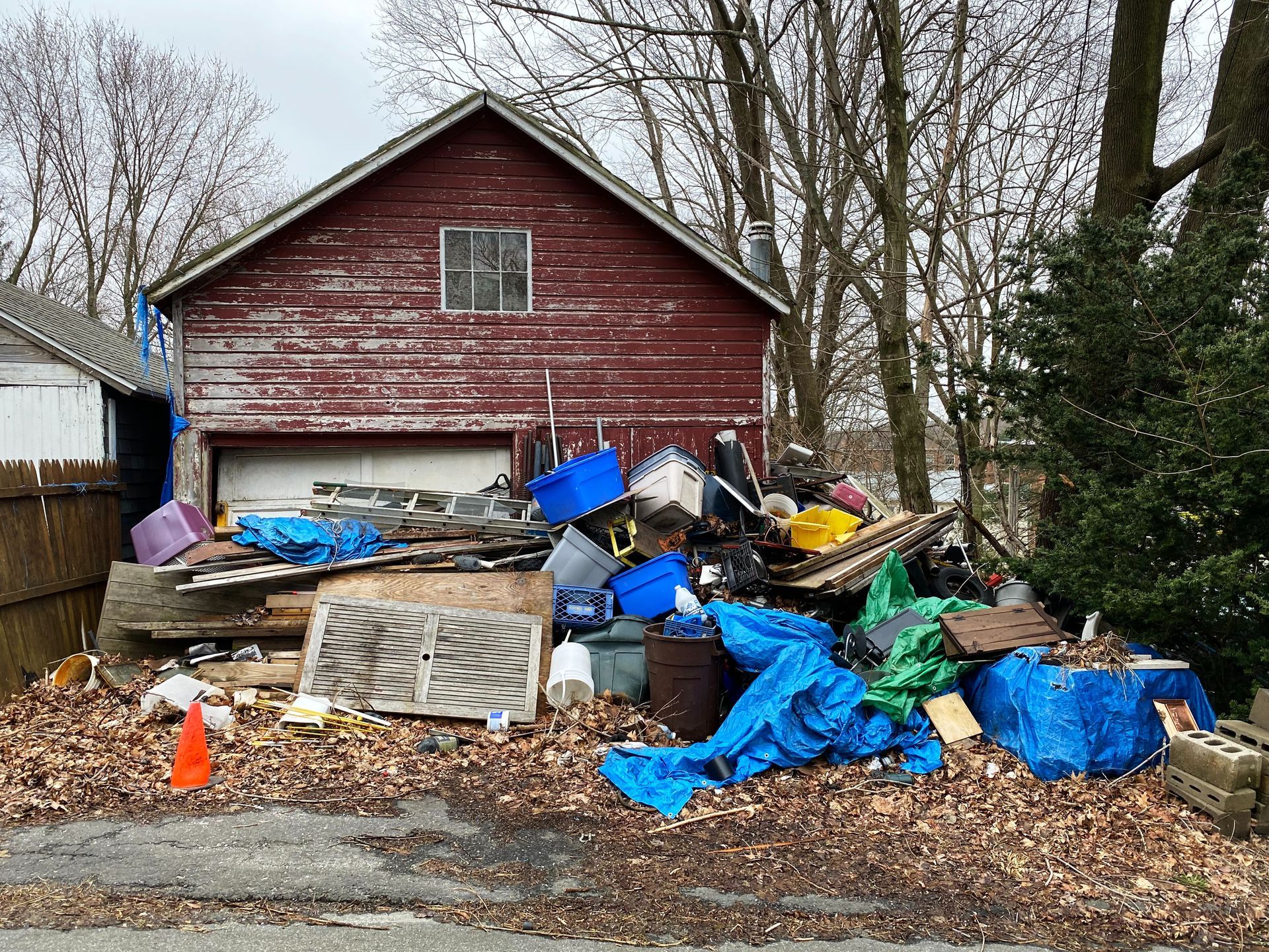a house with a lot of trash in front of it .