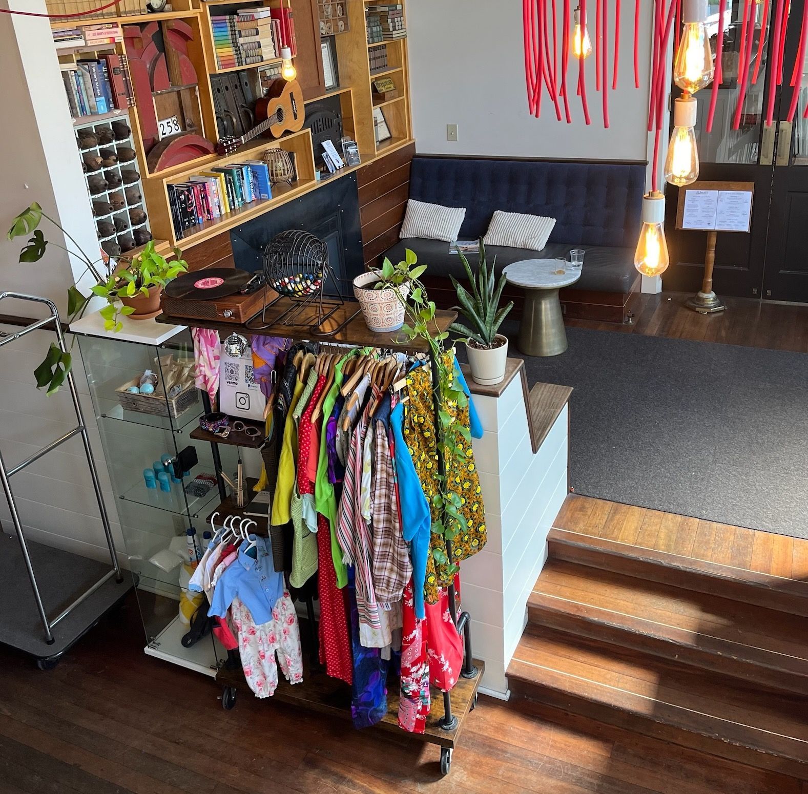 A bunch of clothes are hanging on a rack in a room