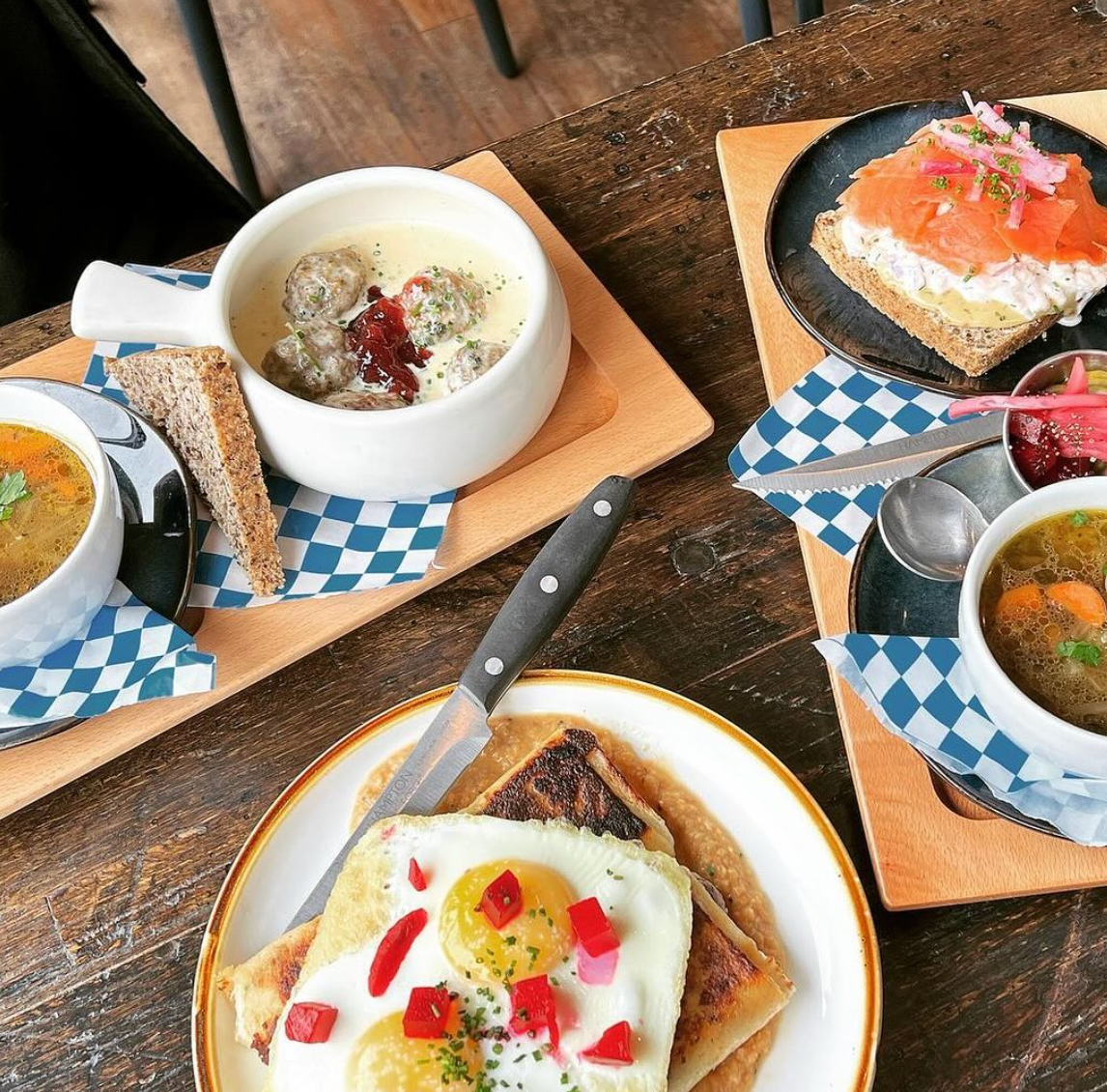 A table topped with plates of food and bowls of soup