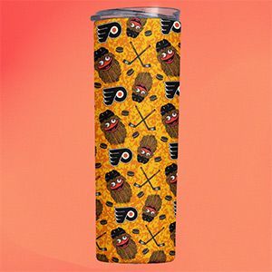 A stainless steel tumbler with a pattern of potatoes and hockey sticks on it.