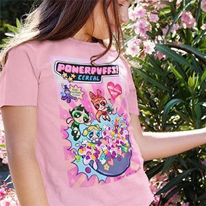 A little girl is wearing a pink powerpuff cereal t-shirt.