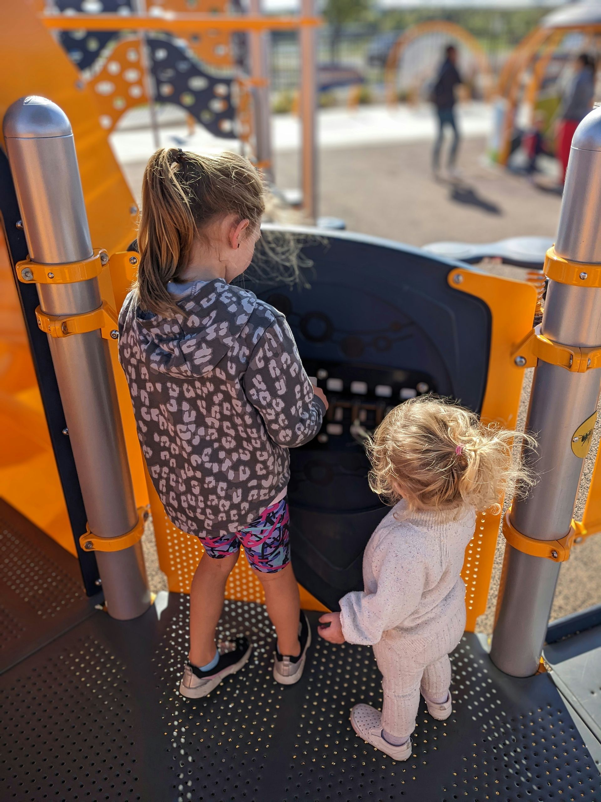 Two little children playing at the park