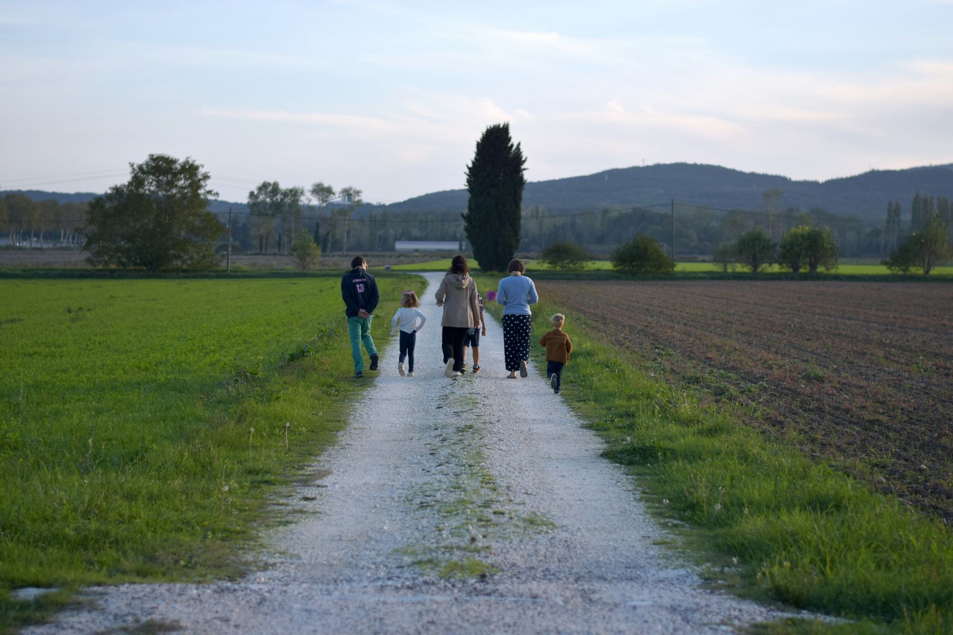 Image of a family walking on a trail together. 