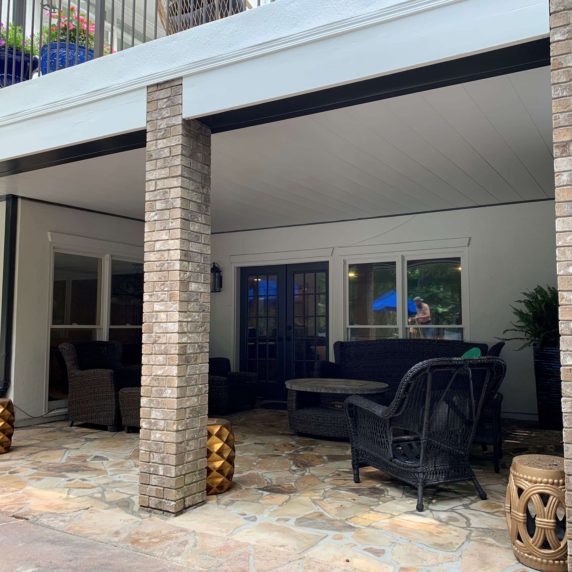 A patio with a lot of furniture and a balcony