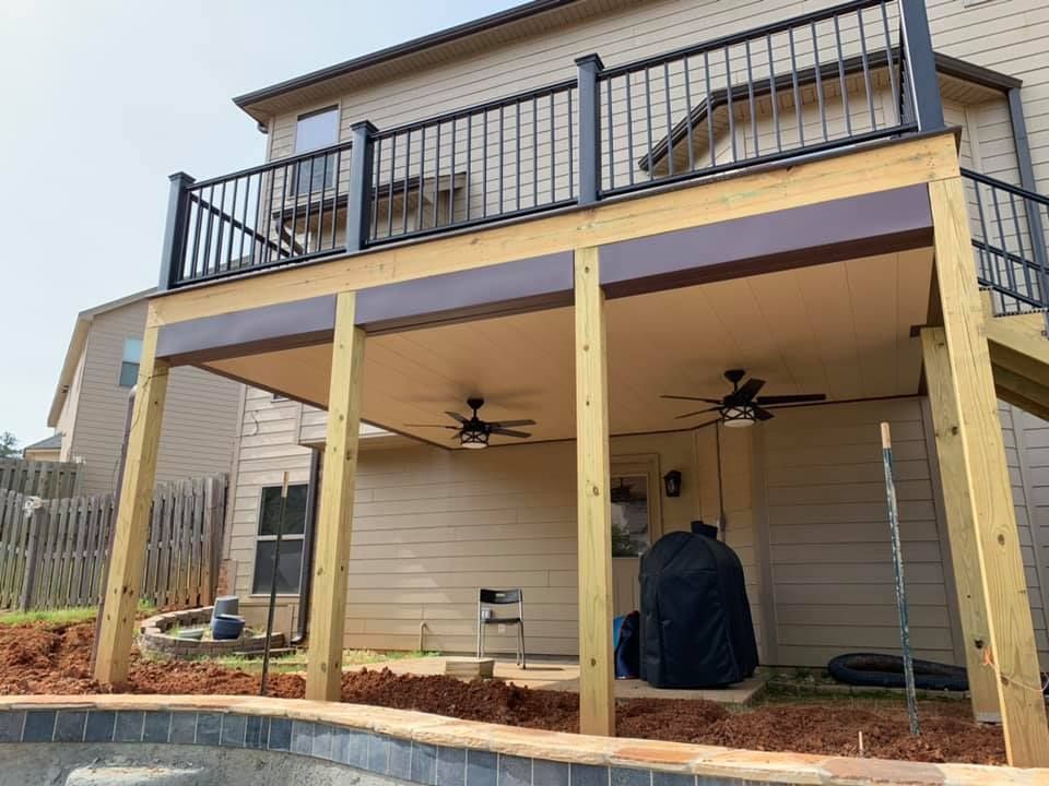There is a large deck with a ceiling fan on it.