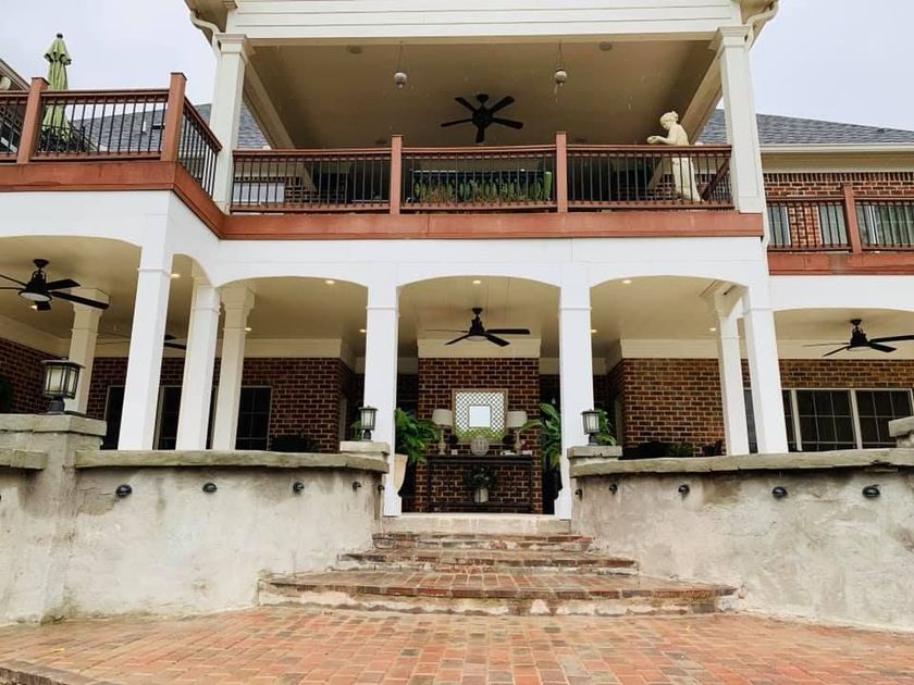 A large house with a large porch and stairs