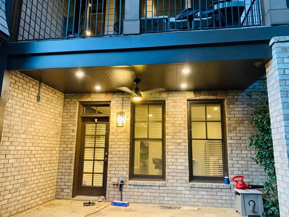 A brick building with a balcony and a ceiling fan.