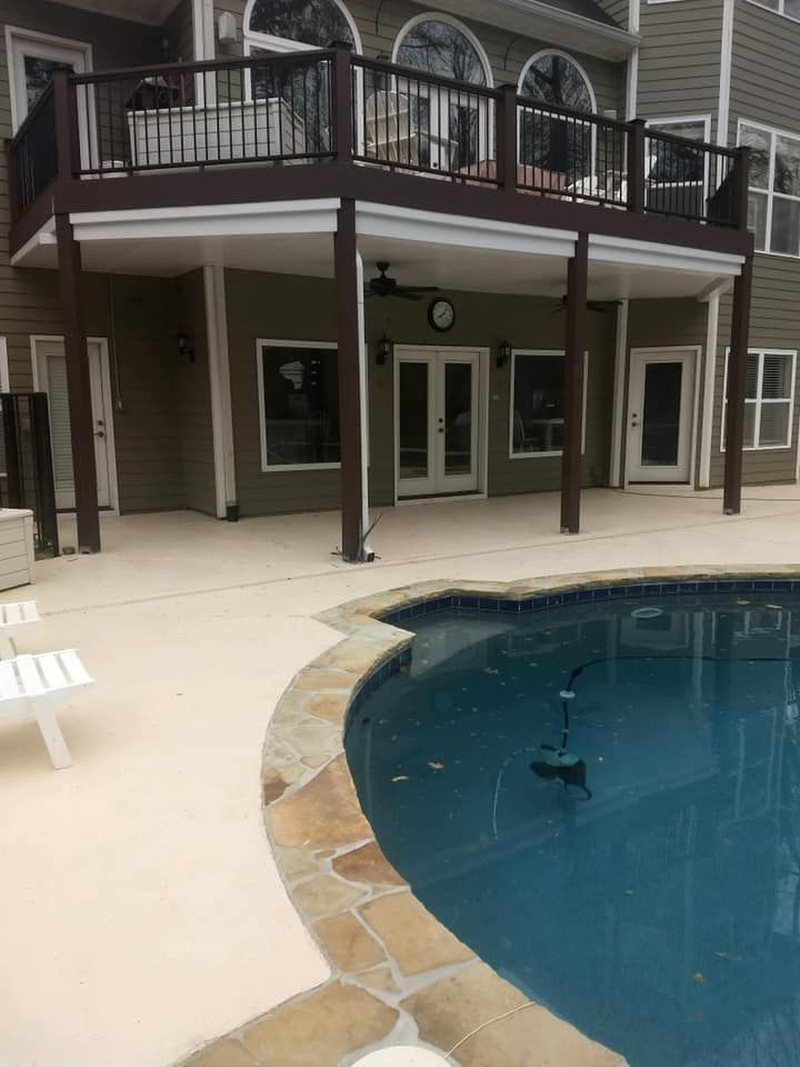 A large house with a swimming pool in front of it