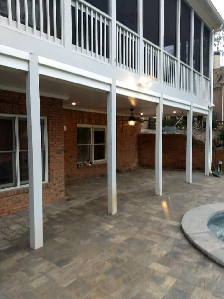 A house with a screened in porch and a pool