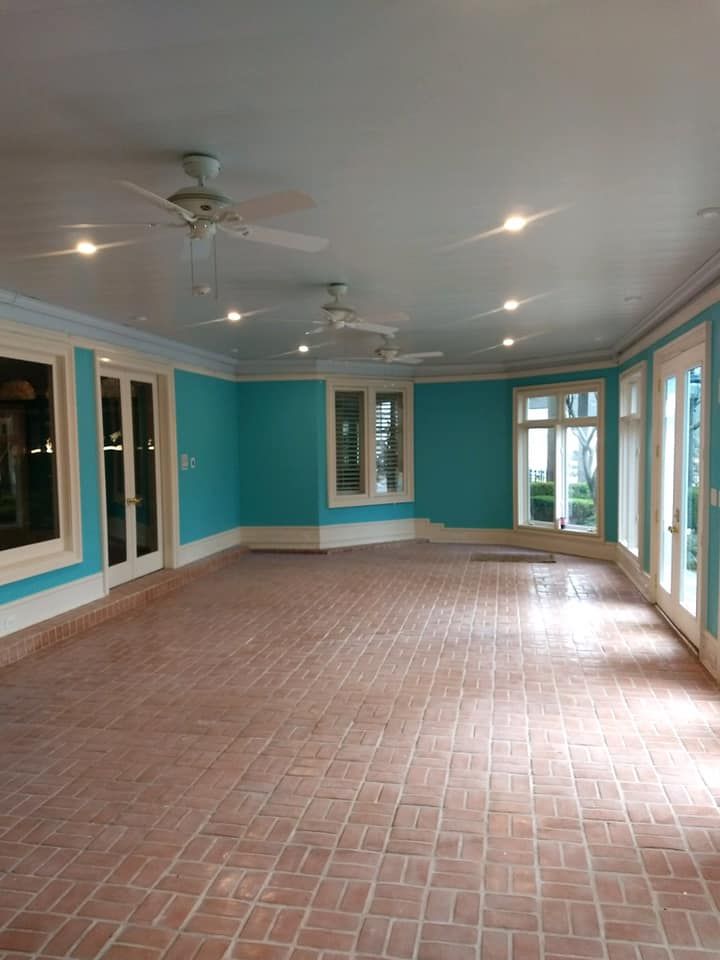 An empty room with blue walls and a tiled floor.