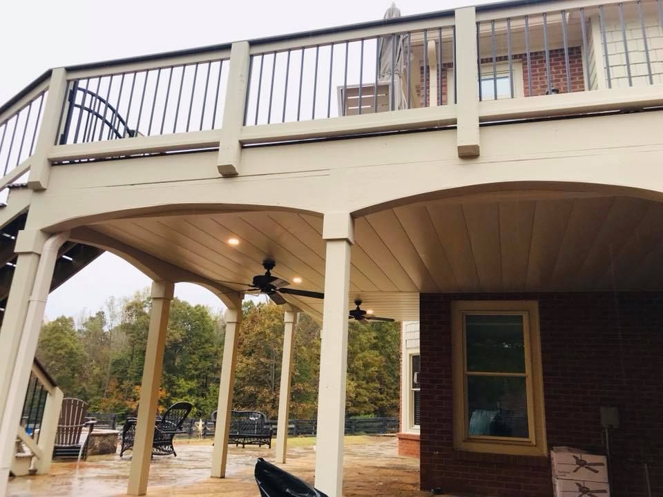 There is a large deck with a ceiling fan on it.