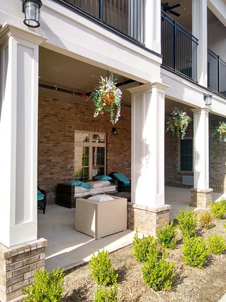 There is a porch with a lot of furniture on it.