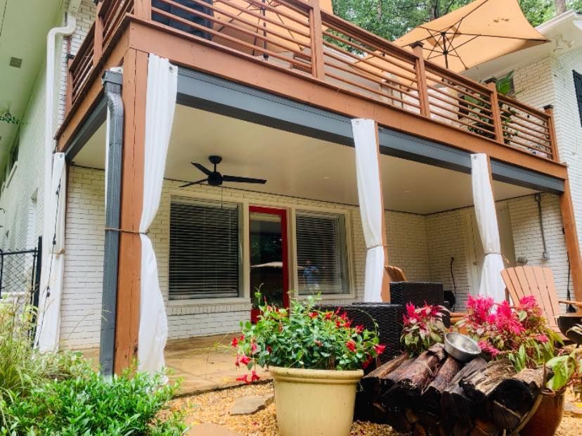 A house with a large deck and a ceiling fan.