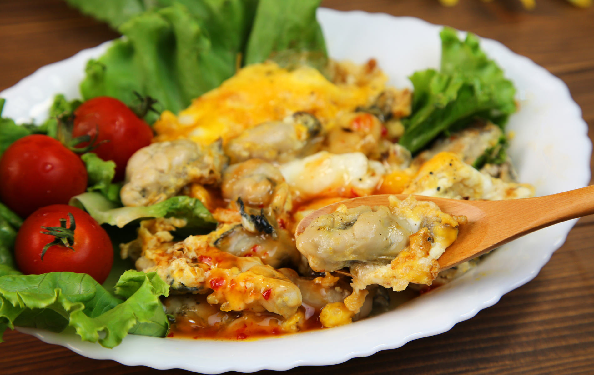 A plate of food with a spoon in it on a table.