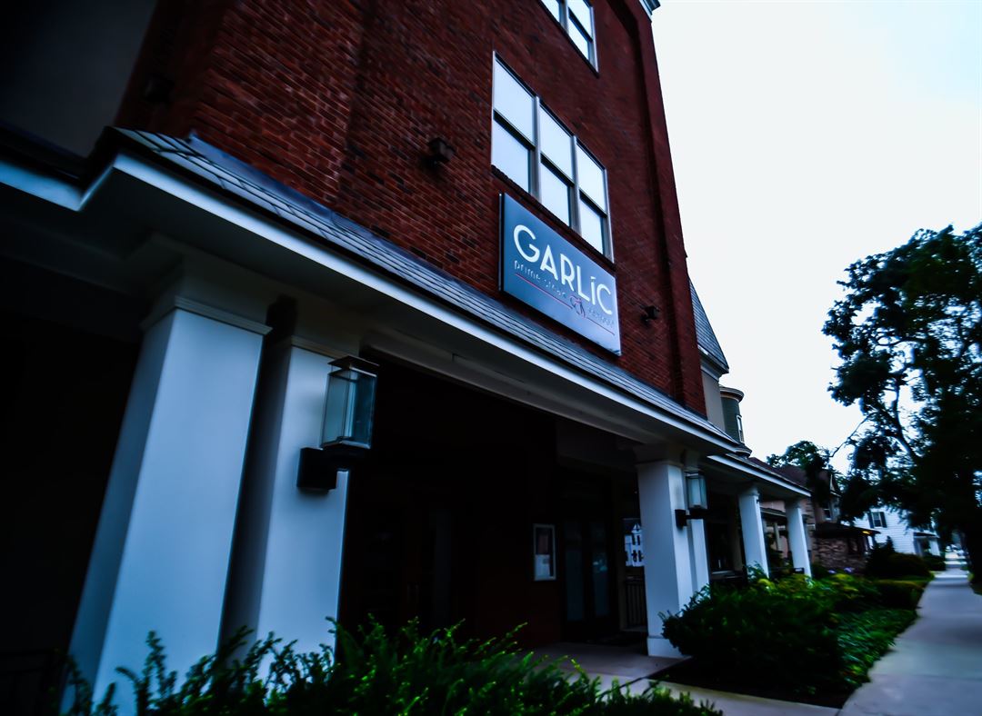 A brick building with a sign that says garlic on it
