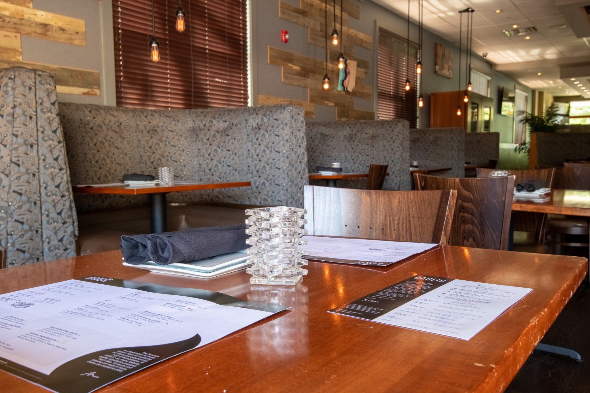 A restaurant with tables and chairs and a menu on the table.