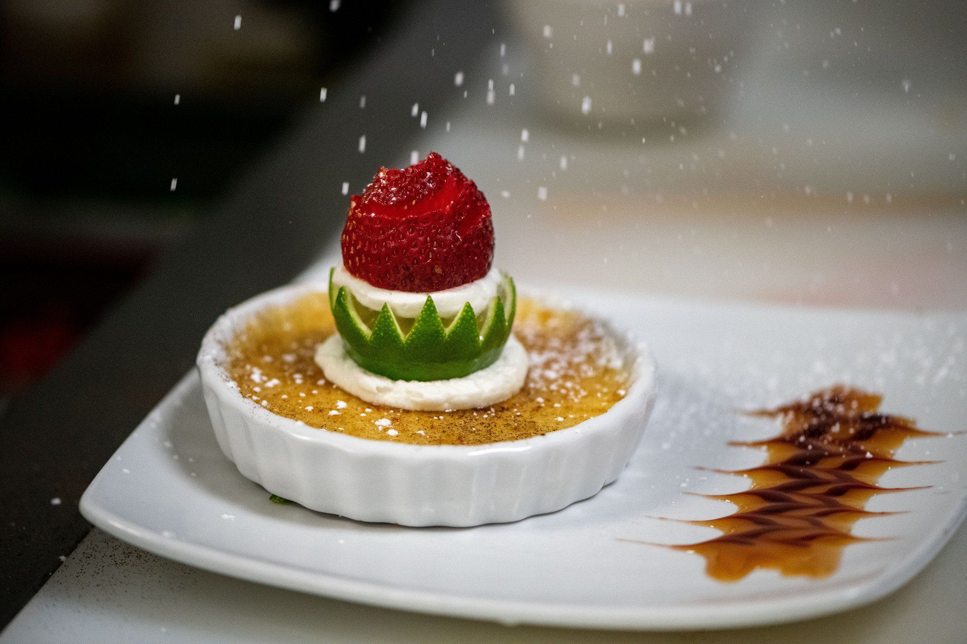 A dessert with a strawberry on top of it on a white plate.