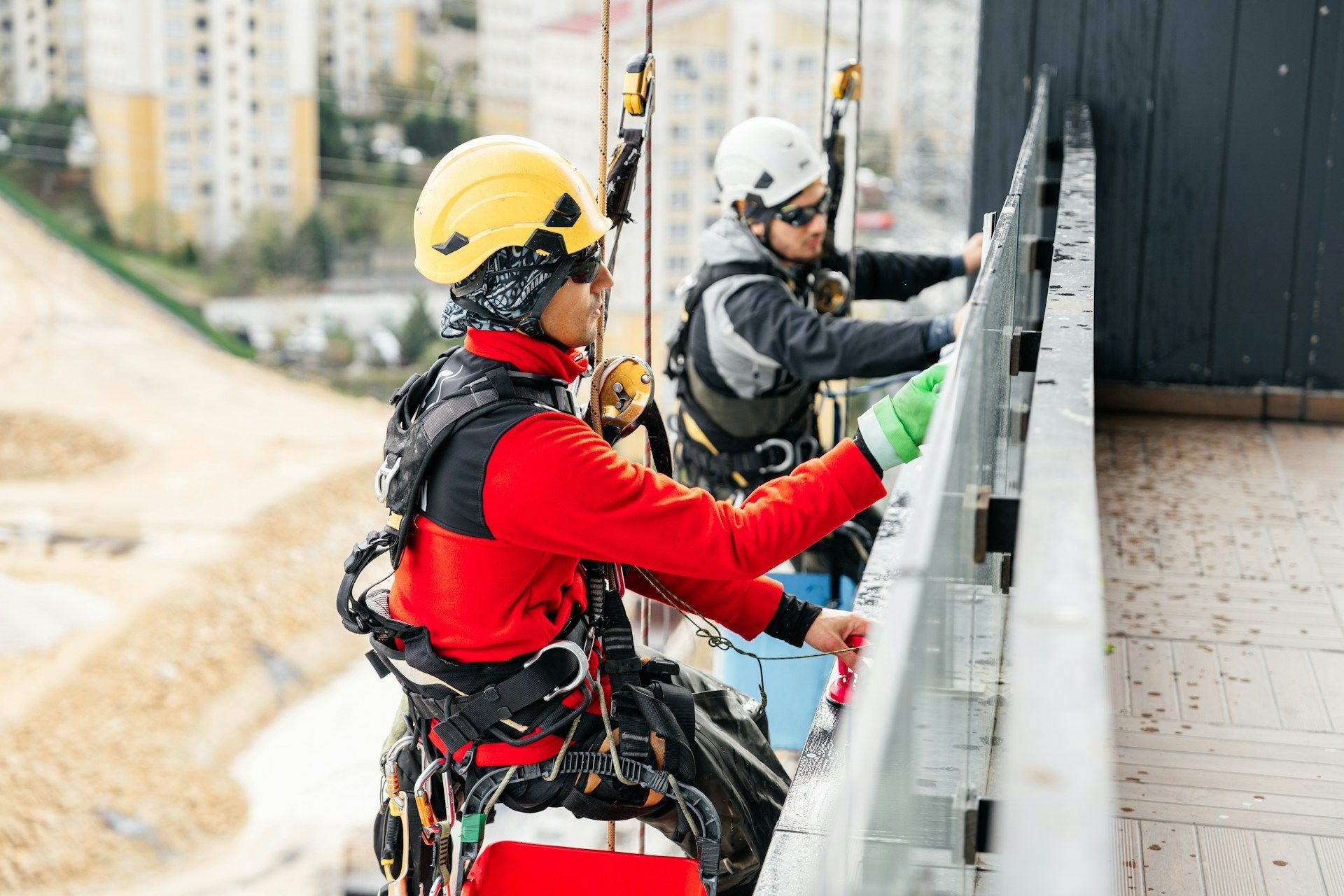 A man in a blue shirt and tie is using a laptop computer.