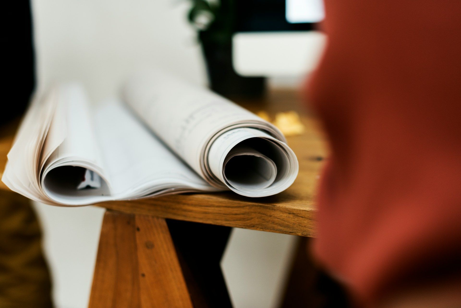 A roll of paper is sitting on a wooden table.