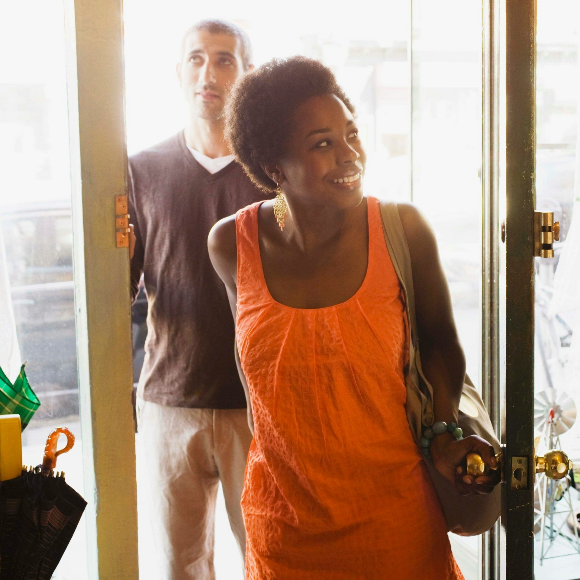 A man in a blue shirt and tie is using a laptop computer.