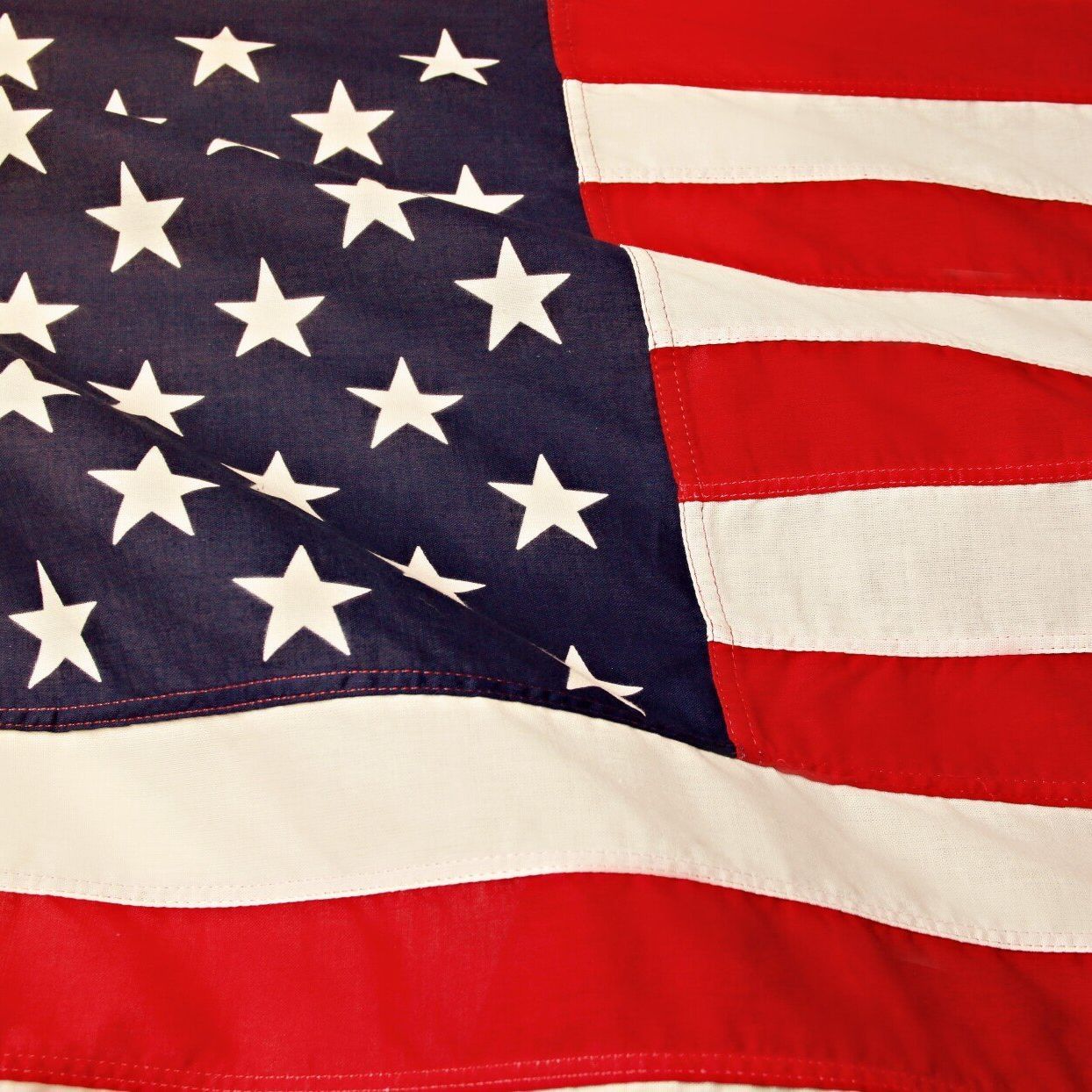 A red white and blue american flag with white stars