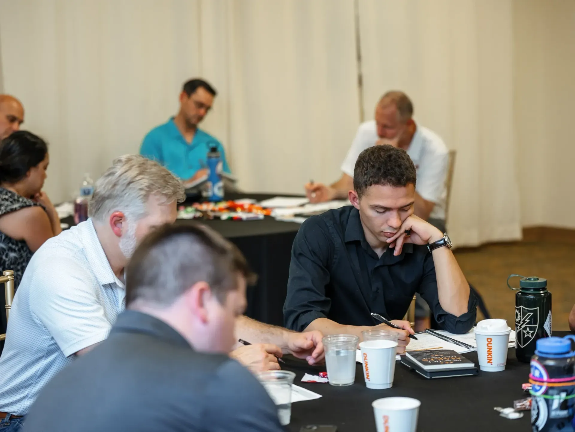 A group of people are sitting around a table having a meeting.