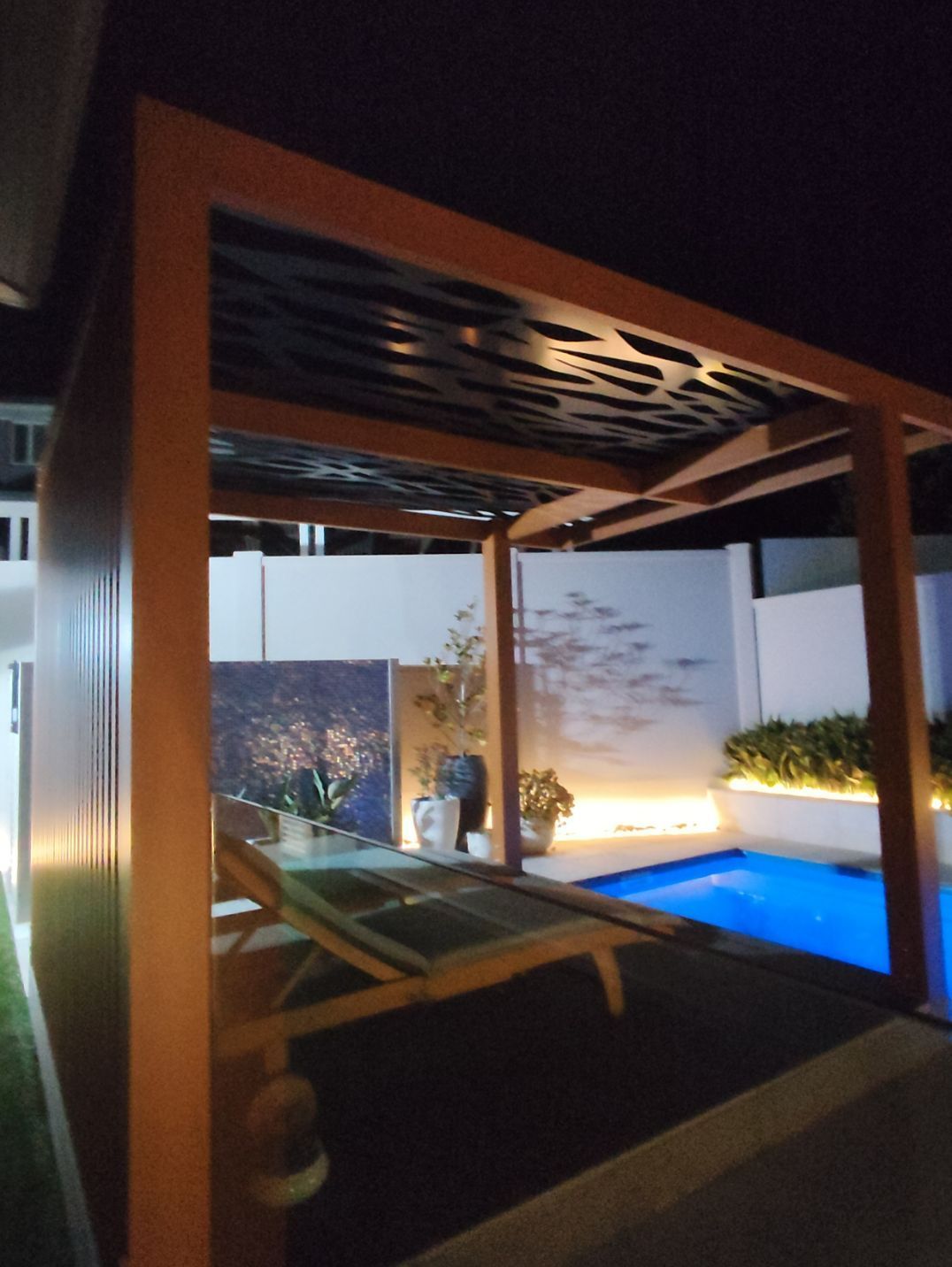 Wooden Pergola Over a Pool With a Lounge Chair — Narellan Home Improvement Centre In Narellan, NSW