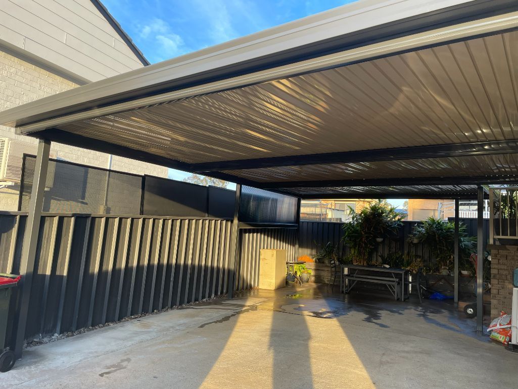 Carport With a Slatted Roof, Casting Shadows on the Driveway — Narellan Home Improvement Centre In Narellan, NSW