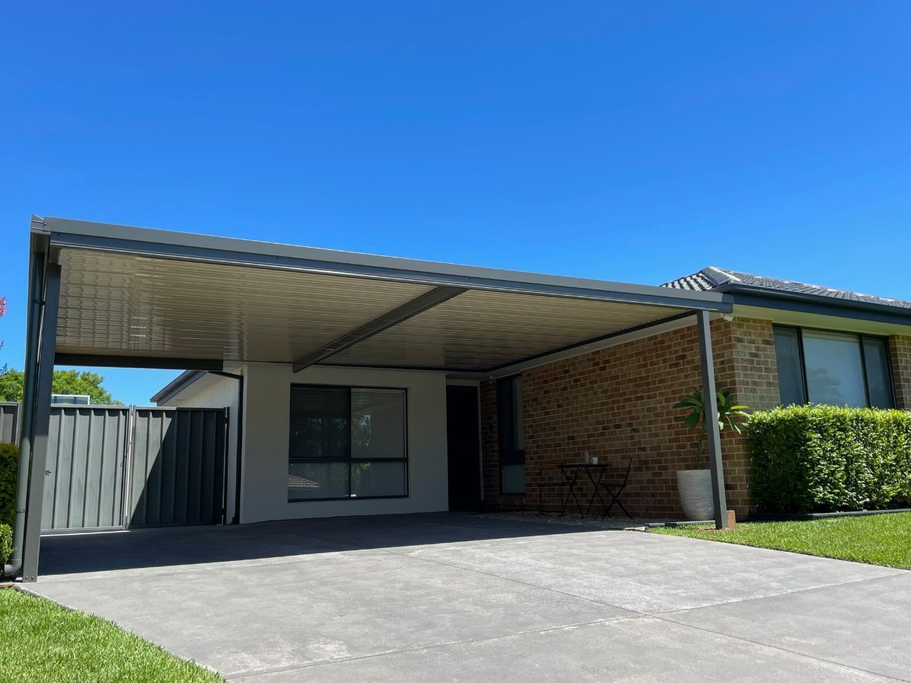 Carport Attached to a Brick House, With a Concrete Driveway — Narellan Home Improvement Centre In Wollongong, NSW