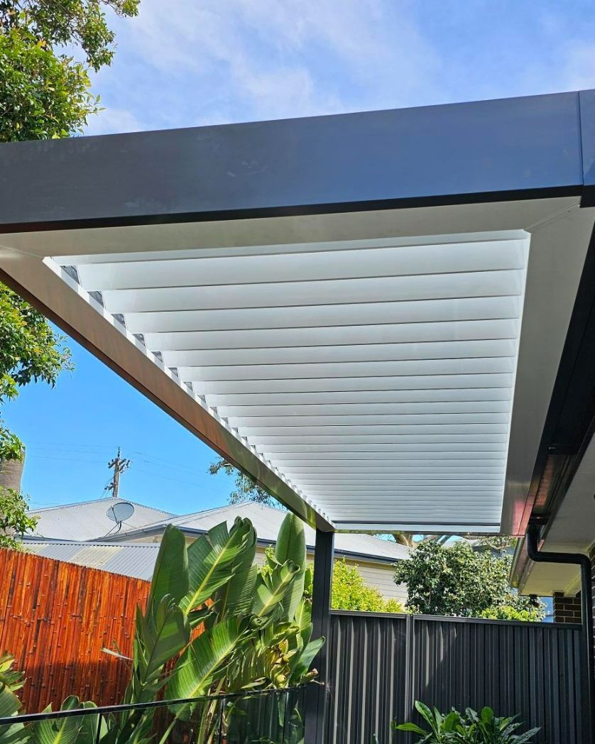 A Modern Outdoor Pergola With White Slats, and Black Frame — Narellan Home Improvement Centre In Coffs Harbour, NSW