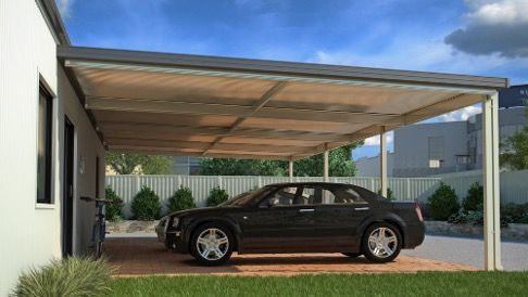 Dark sedan parked under a carport attached to a white building — Narellan Home Improvement Centre In Narellan, NSW