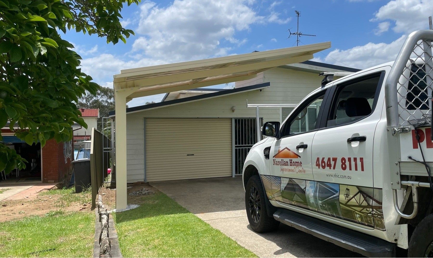 Tan-colored Patio Enclosure With Brick Base, Next to a Grey Fence — Narellan Home Improvement Centre In Narellan, NSW