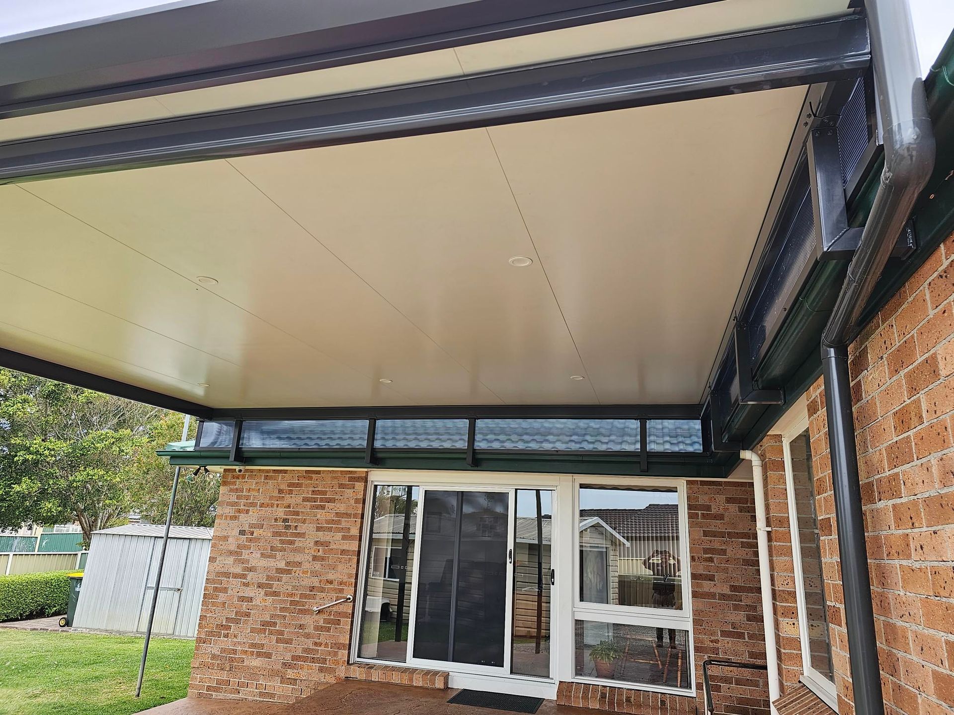 Beige Building With a Balcony, Awning, and Palm Trees — Narellan Home Improvement Centre In Narellan, NSW
