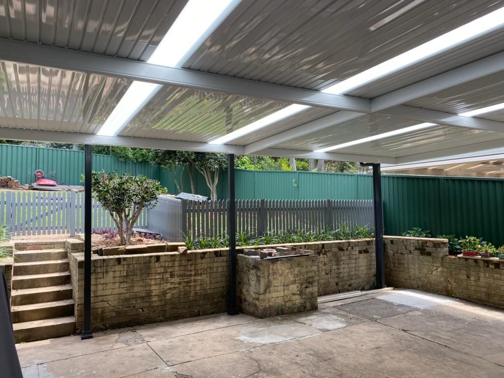 Patio With White Roof, Black Pillars, and Concrete Floor — Narellan Home Improvement Centre In Wollongong, NSW