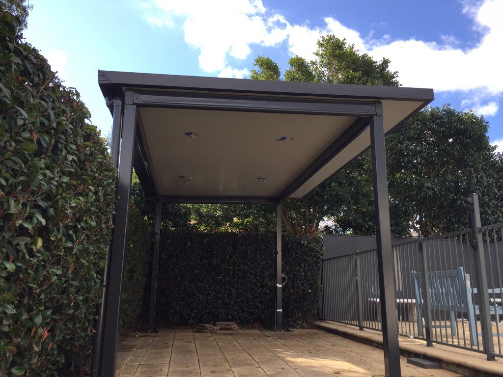 Black Metal Pergola With a Beige Ceiling — Narellan Home Improvement Centre In Liverpool, NSW