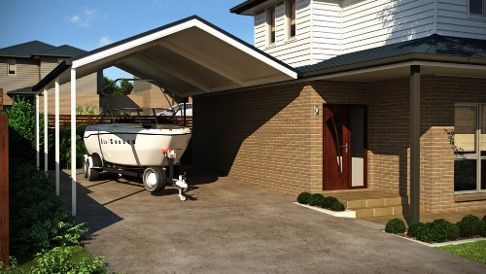 Carport attached to a brick house, with a boat trailer parked underneath — Narellan Home Improvement Centre In Narellan, NSW