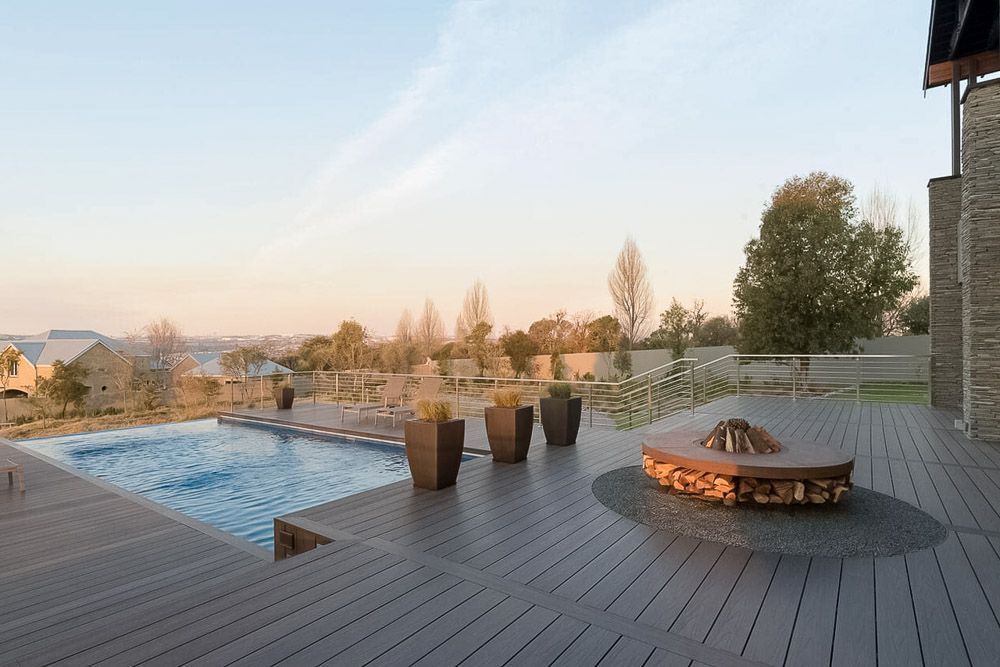 Outdoor Deck With Pool, Fire Pit, and Potted Plants — Narellan Home Improvement Centre In Narellan, NSW