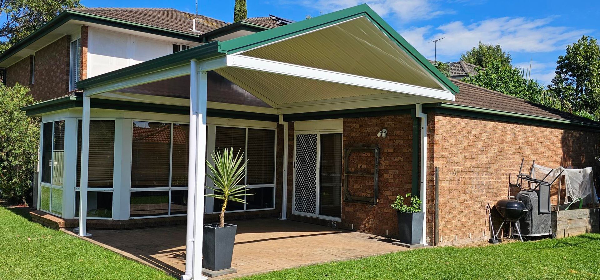 Two-story House With Glass Balcony, Garage Doors, Red Roof Trim — Narellan Home Improvement Centre In Narellan, NSW