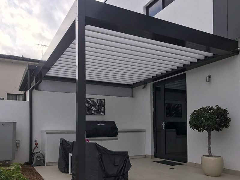 Black Pergola Over an Outdoor Patio — Narellan Home Improvement Centre In Narellan, NSW